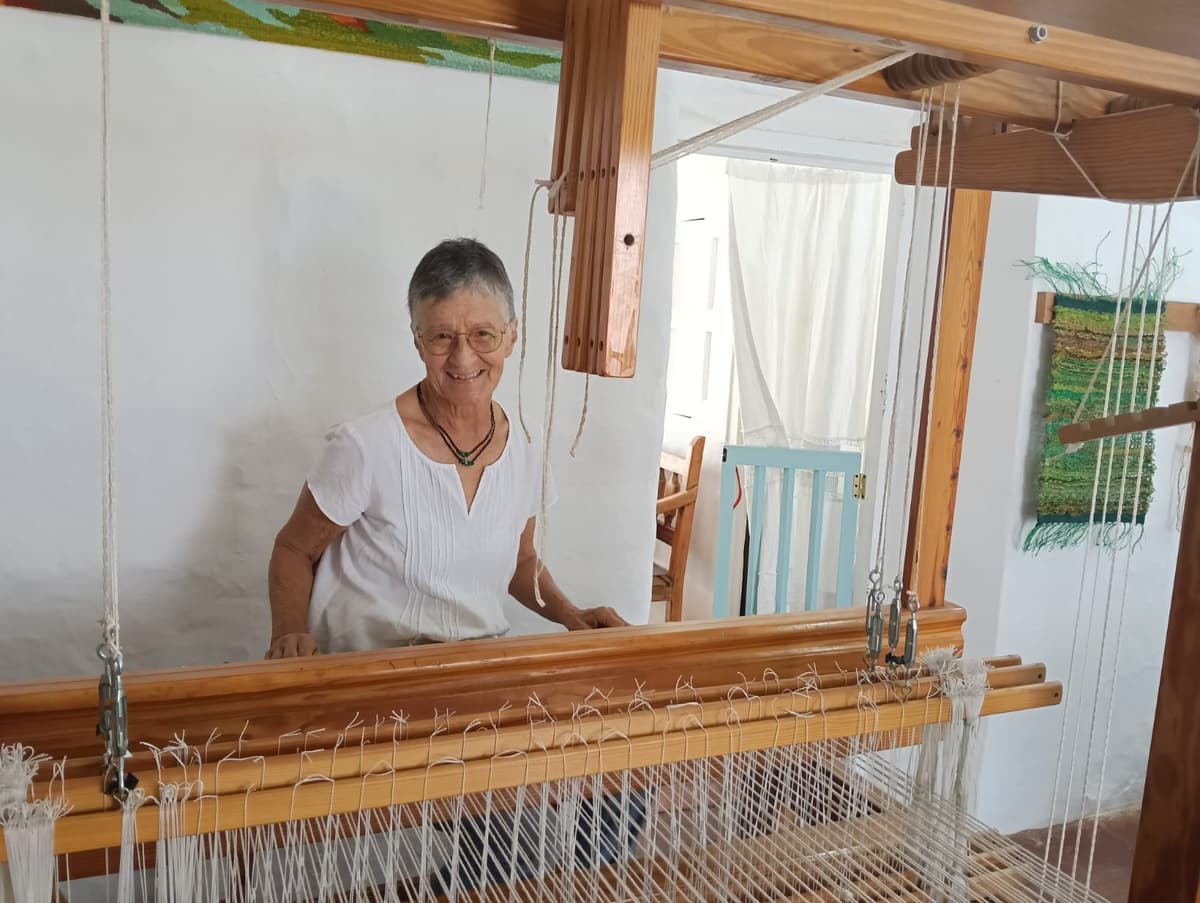 Silvia estudiando en mesa con sus tapices de fondo